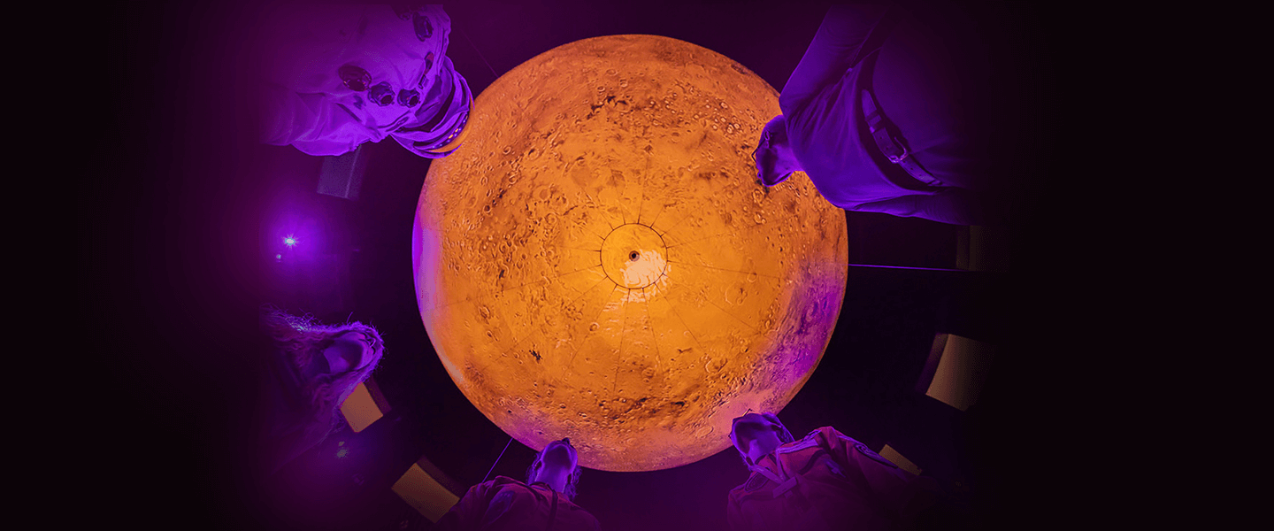 People around orange orb representing Mars