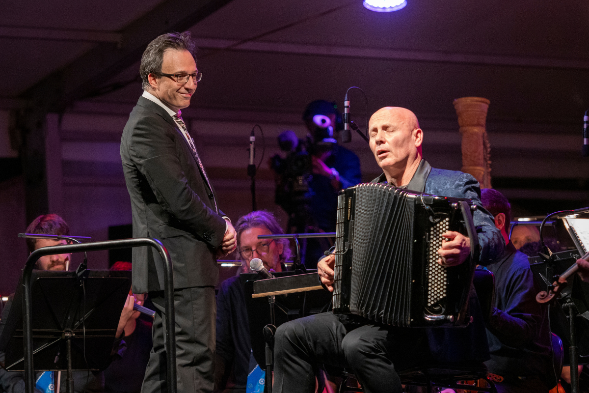 Image of conductor and accordion player