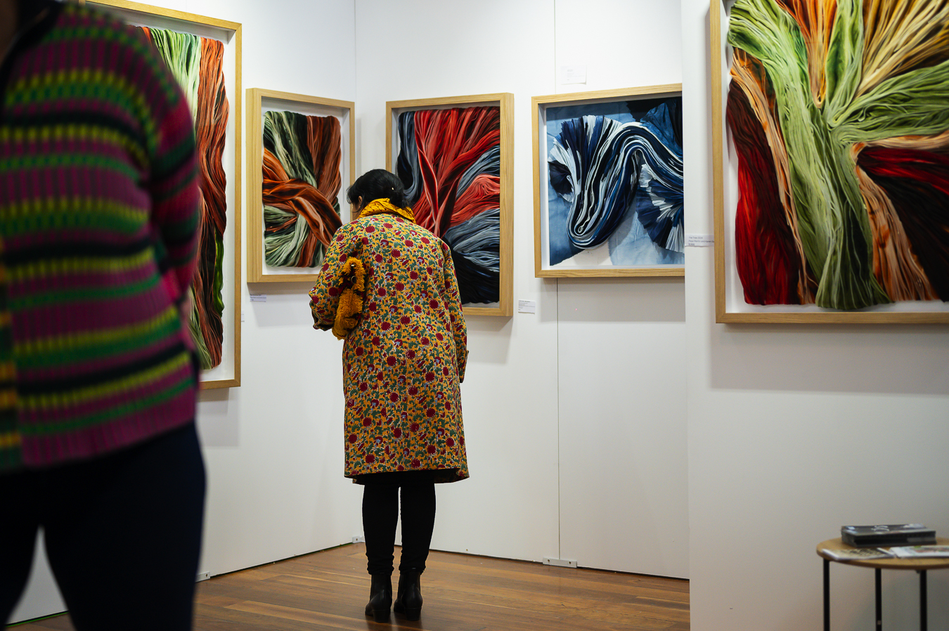 Person looking at art exhibiting at Affordable Art Fair Melbourne