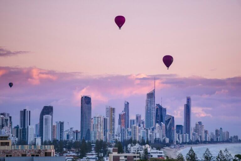 Brisbane Skyline Image of Brisbane skyline. Purple sunset with hot air balloon in sky.