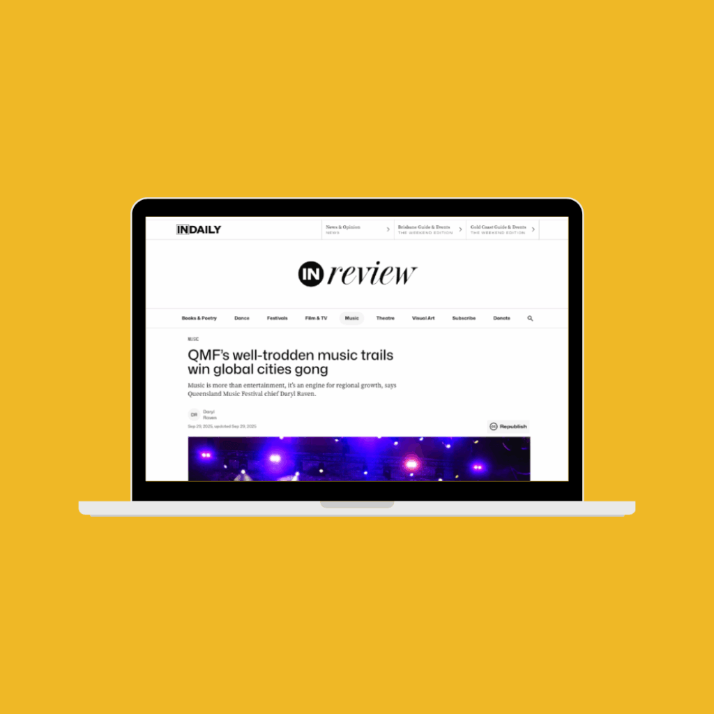 Yellow background with image of laptop screen within. Screen features an online news article from InDaily Queensland about Queensland Music Trails The Tropics which is titled 'QMF's well-trodden music trails win global cities gong.'