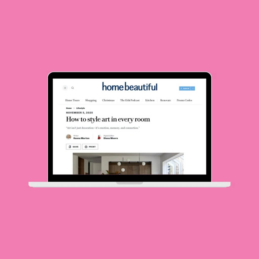 Pink background with laptop screen in centre. Home Beautiful article on screen.